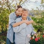 Old woman in a garden with young granddaughter